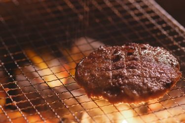 grilled-beef-burger-on-barbecue-metal-net